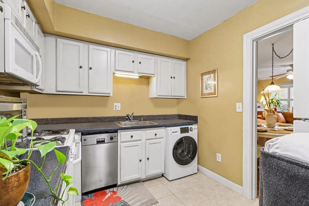2477 North Decatur Road, Unit A1 Decatur, GA 30033 - Photo 4 of 29 a kitchen with a stove a sink and a cabinets