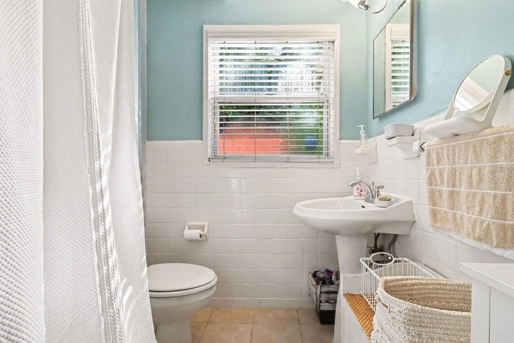 2477 North Decatur Road, Unit A1 Decatur, GA 30033 - Photo 6 of 29 a bathroom with a sink a toilet and a window
