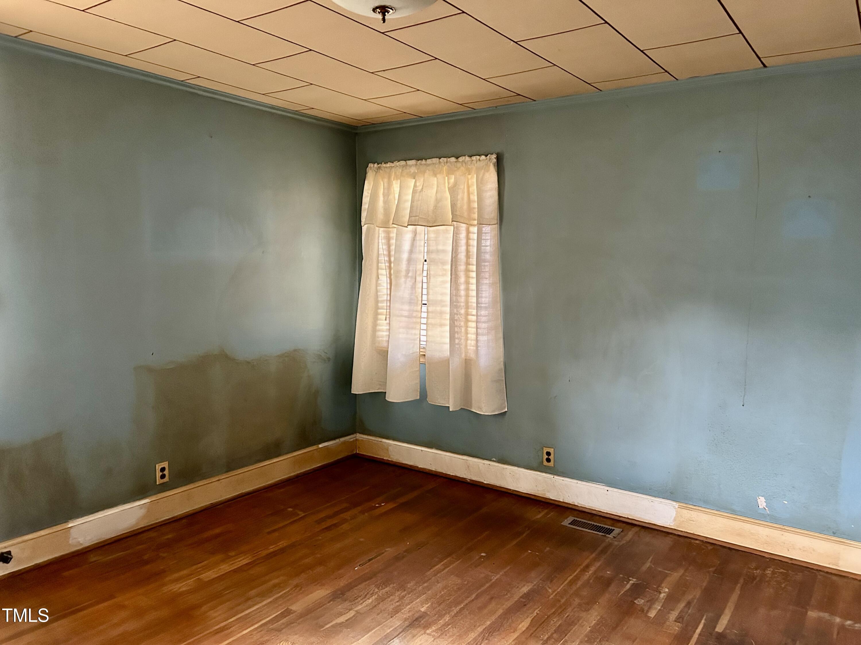 3526 Rose Of Sharon Road Durham, NC 27712 - Photo 8 of 11 an empty room with wooden floor and windows