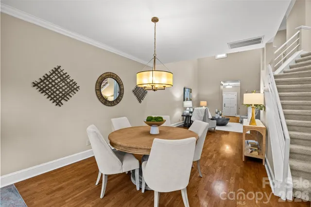 a kitchen with stainless steel appliances granite countertop a stove a sink and a white cabinets