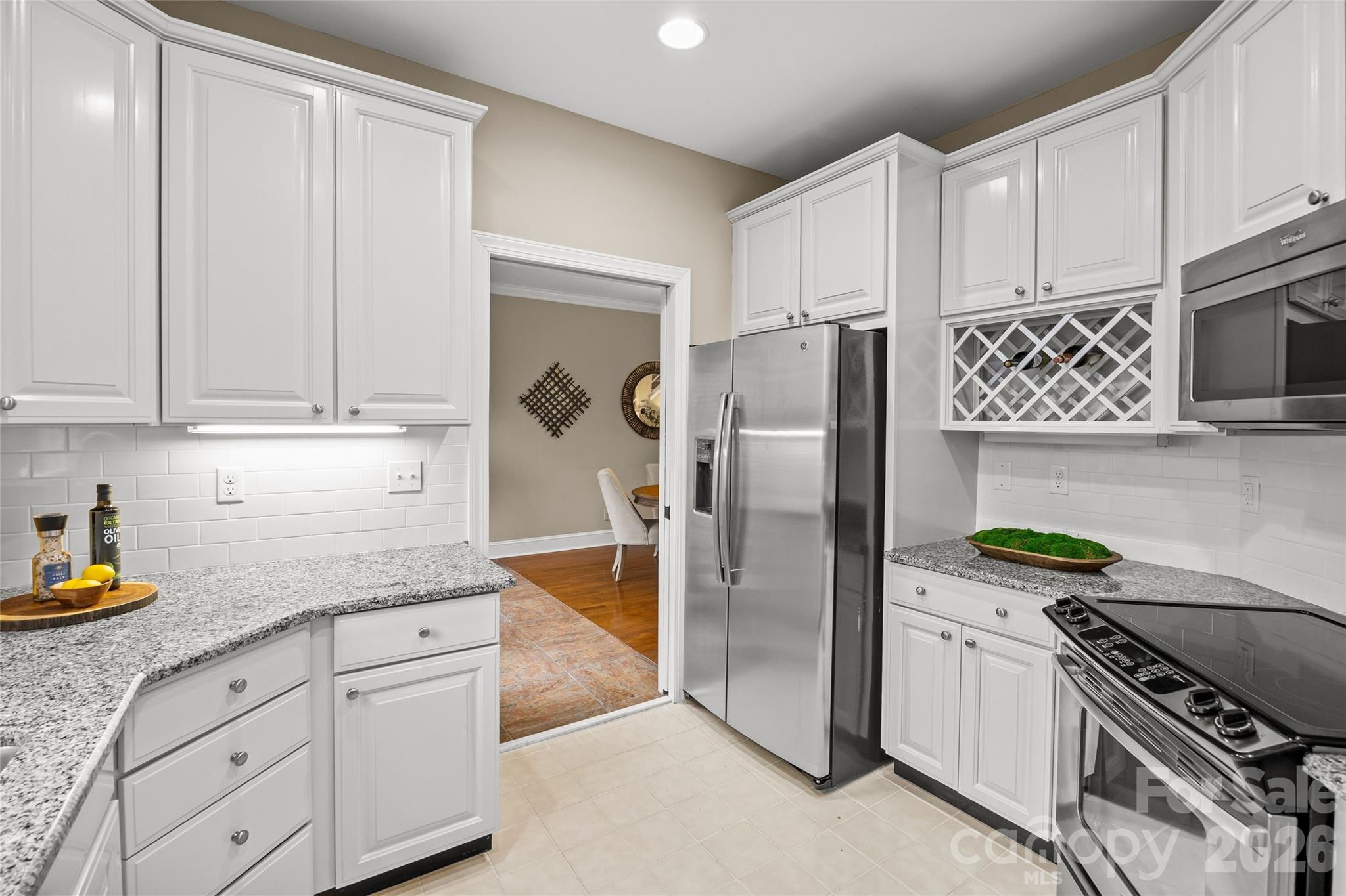 6029 Sharon Road Charlotte, NC 28210 - Photo 15 of 47 a kitchen with stainless steel appliances granite countertop a refrigerator and a stove