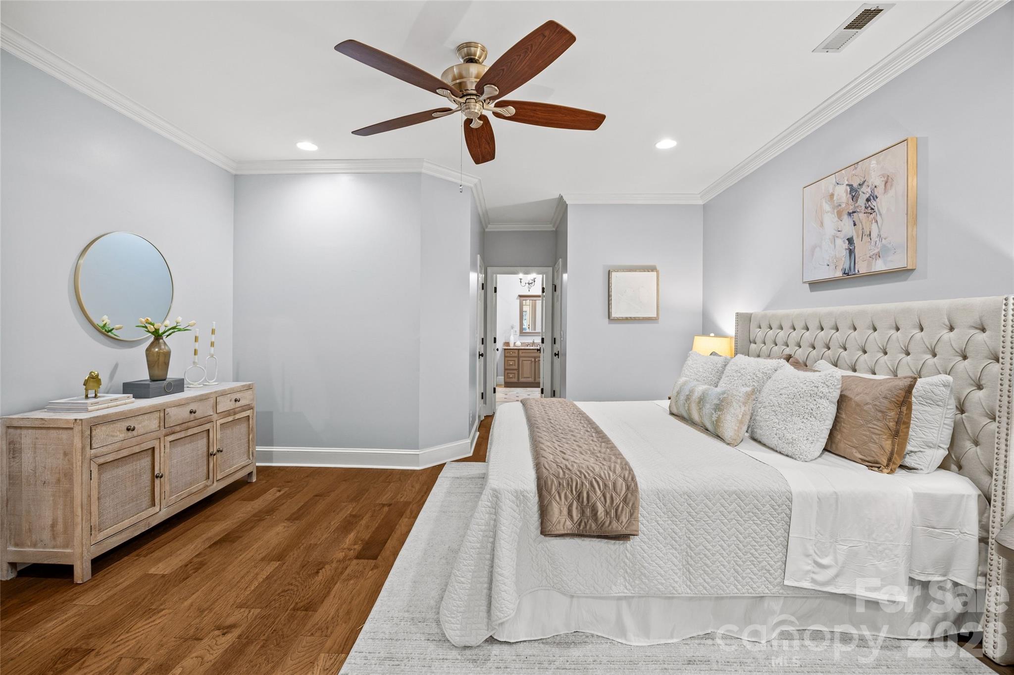 6029 Sharon Road Charlotte, NC 28210 - Photo 17 of 47 a bedroom with a large bed and a chandelier