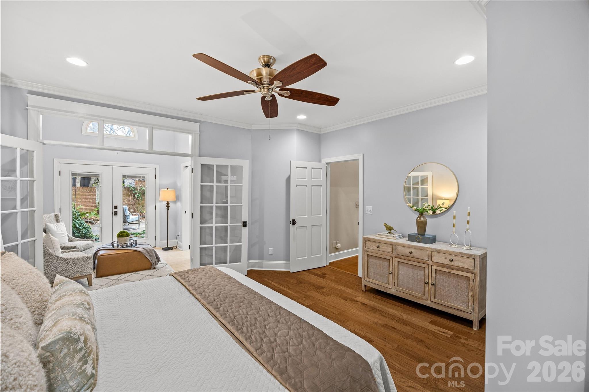 6029 Sharon Road Charlotte, NC 28210 - Photo 18 of 47 a bedroom with a large bed and a chandelier