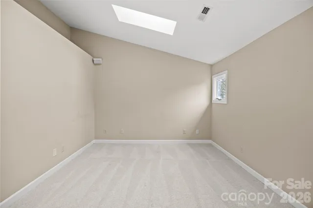 a view of a livingroom with a ceiling fan and window