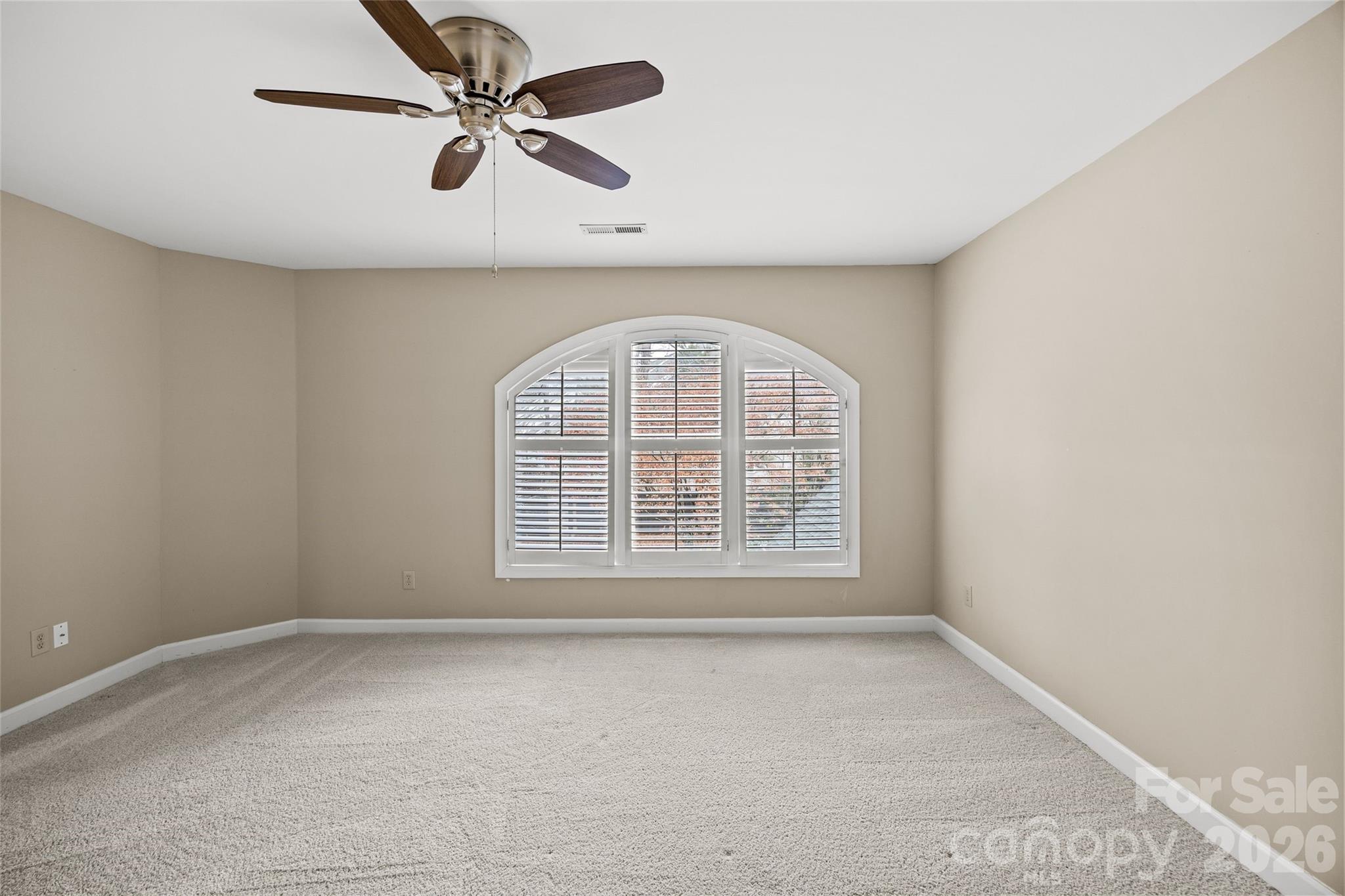6029 Sharon Road Charlotte, NC 28210 - Photo 30 of 47 an empty room with a window and a fan