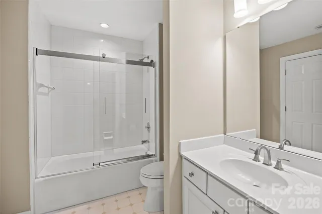 a bathroom with a sink vanity granite tub and a mirror