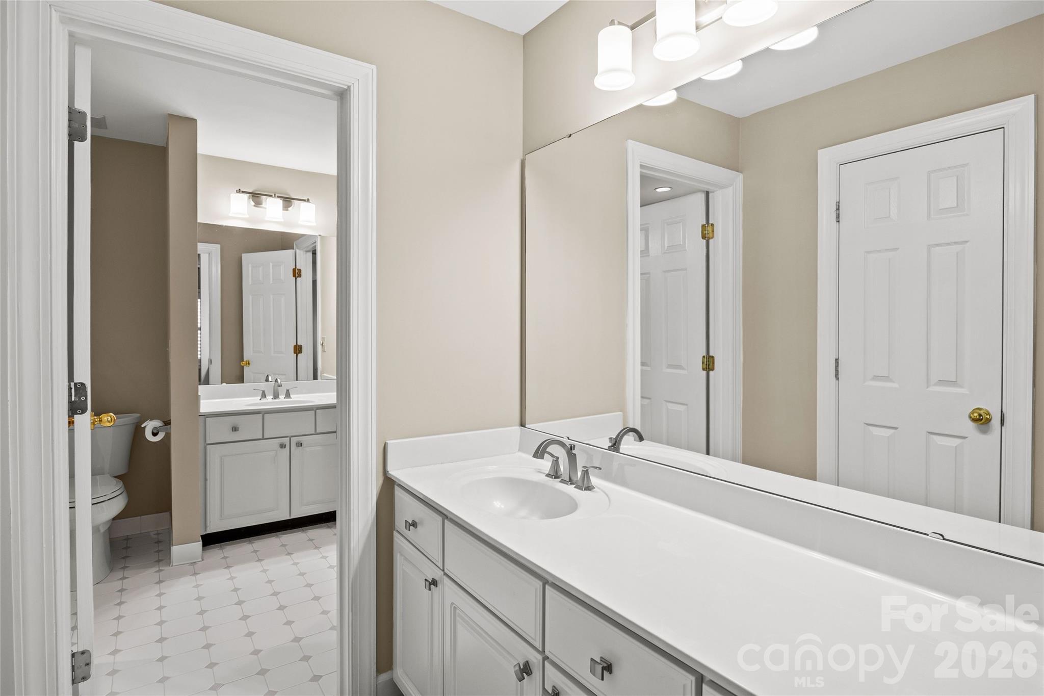 6029 Sharon Road Charlotte, NC 28210 - Photo 37 of 47 a bathroom with a sink vanity granite tub and a mirror