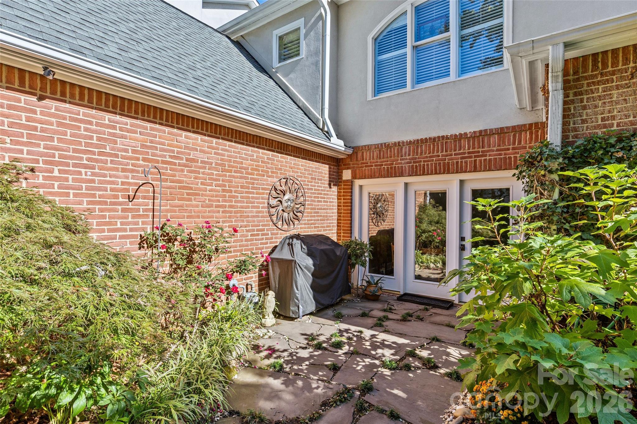 6029 Sharon Road Charlotte, NC 28210 - Photo 38 of 47 a view of a patio with table and chairs and potted plants