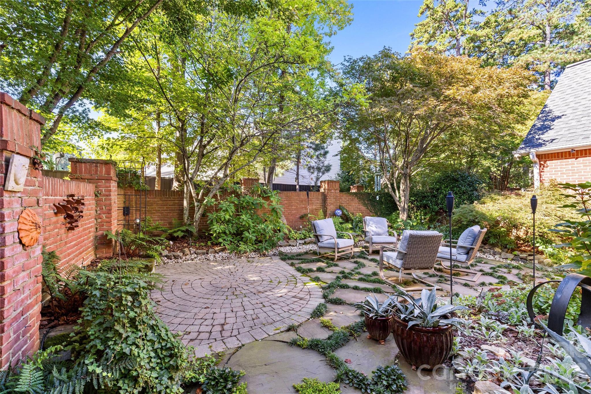 6029 Sharon Road Charlotte, NC 28210 - Photo 40 of 47 a backyard of a house with lots of green space