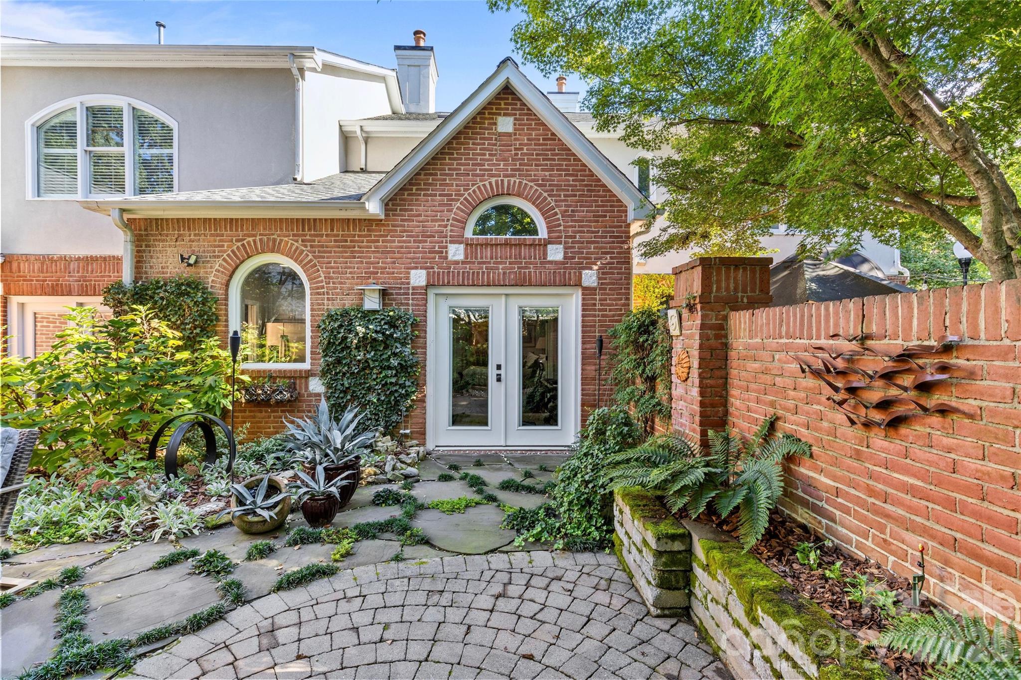 6029 Sharon Road Charlotte, NC 28210 - Photo 41 of 47 a front view of a house with garden