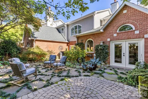 a view of a yard with plants and trees