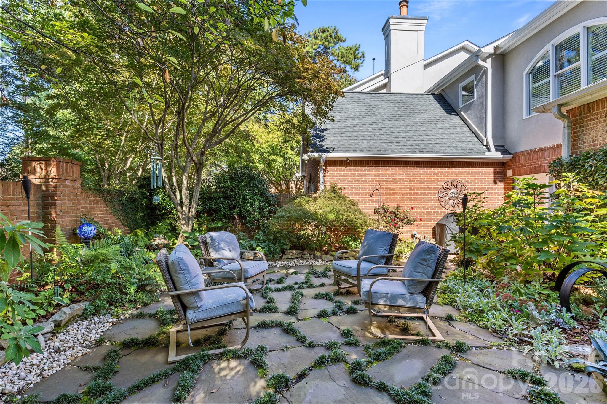 6029 Sharon Road Charlotte, NC 28210 - Photo 43 of 47 a view of a patio with table and chairs and potted plants