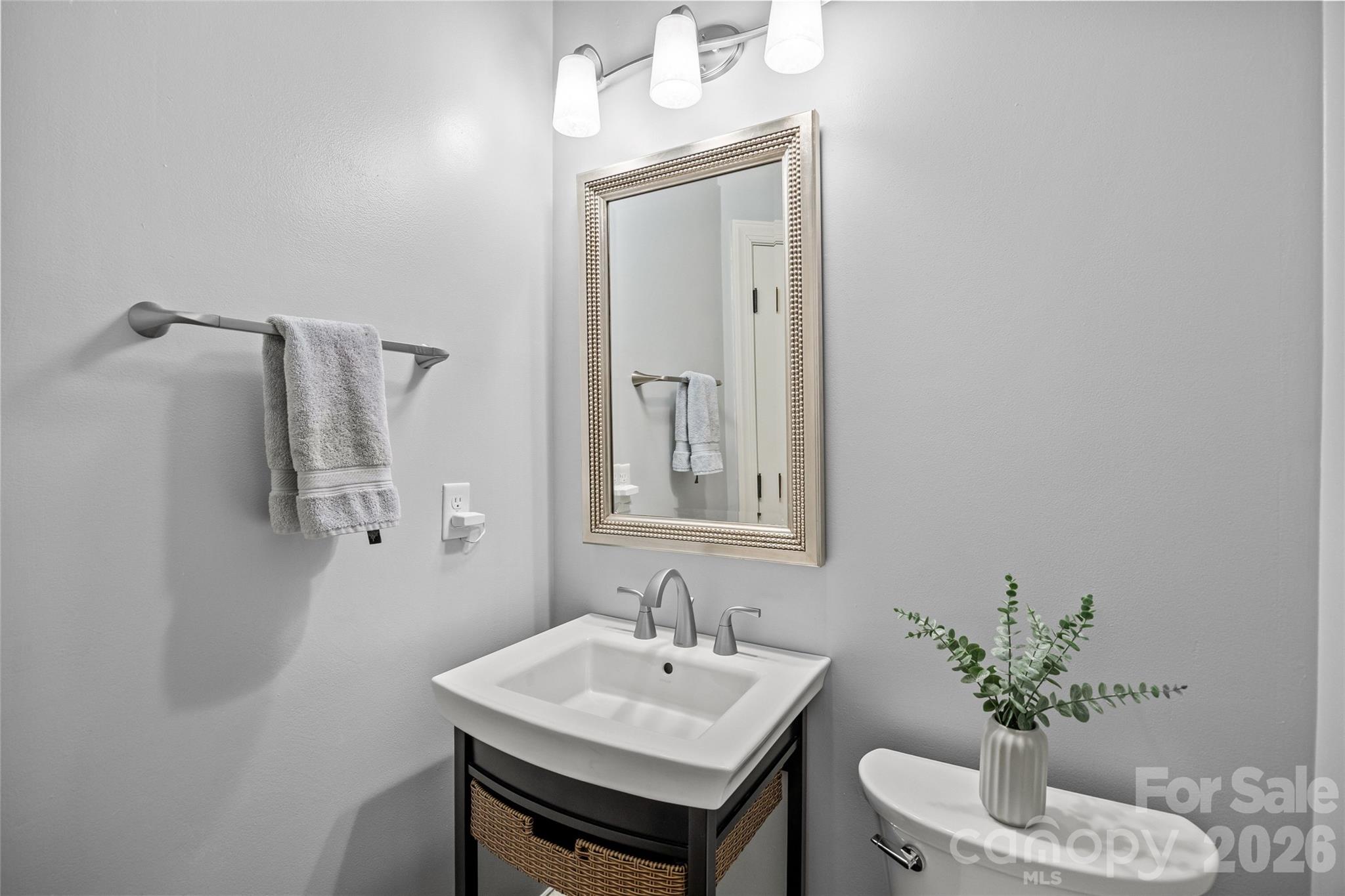6029 Sharon Road Charlotte, NC 28210 - Photo 5 of 47 a bathroom with a sink a toilet and mirror