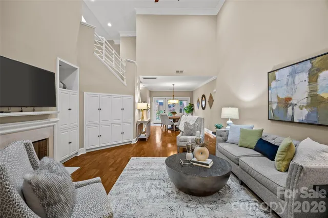 a living room with furniture a fireplace and a flat screen tv
