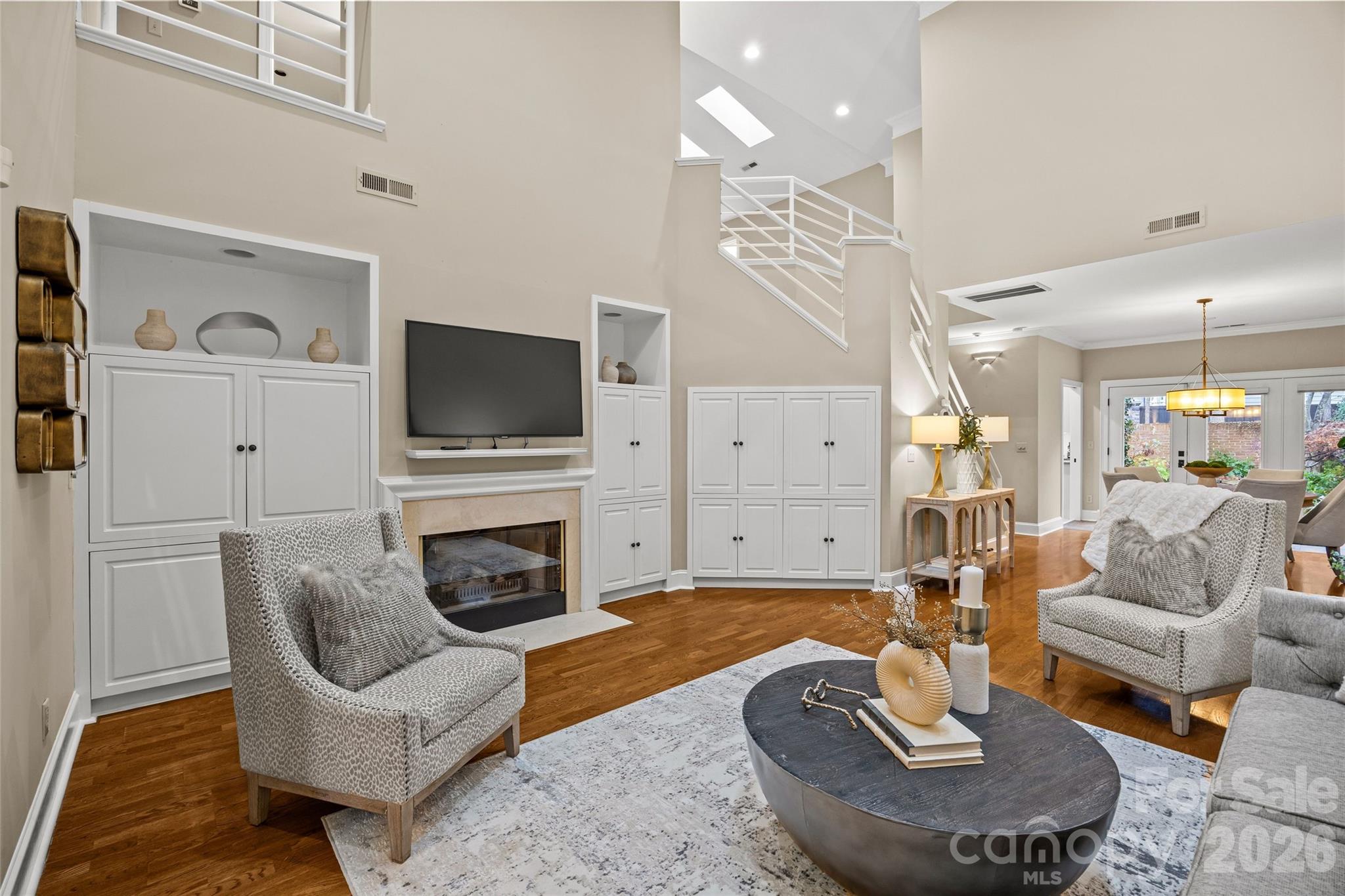 6029 Sharon Road Charlotte, NC 28210 - Photo 7 of 47 a living room with furniture a fireplace and a flat screen tv