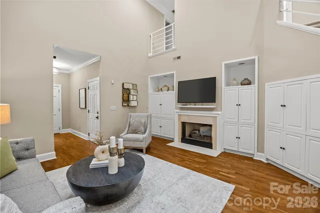a dining room with furniture a chandelier and wooden floor