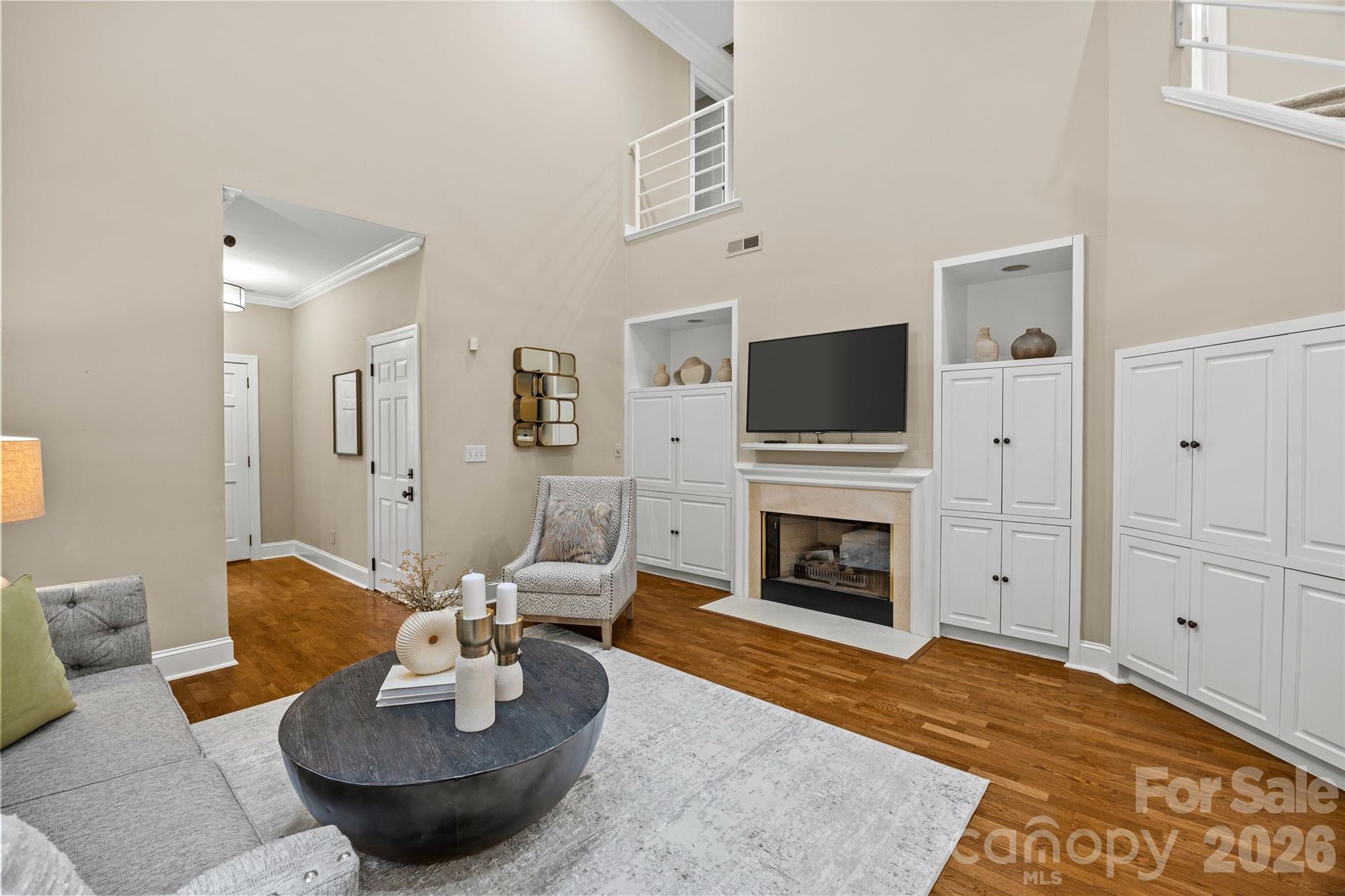 6029 Sharon Road Charlotte, NC 28210 - Photo 10 of 47 a living room with furniture a fireplace and a flat screen tv