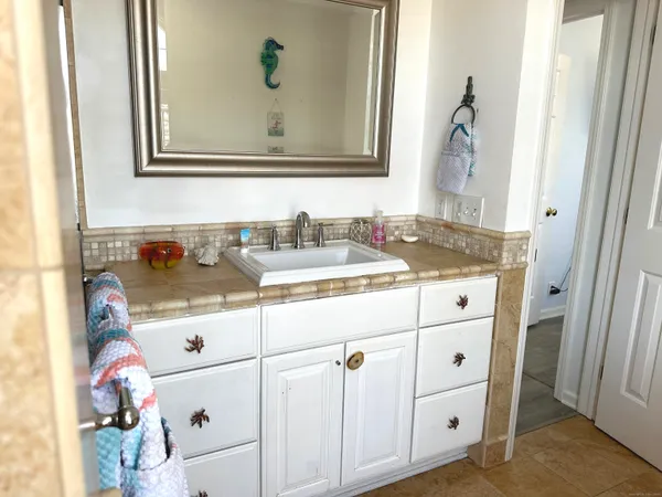 a bedroom with a bed chair and window