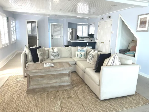 a view of a dining room with furniture large window and wooden floor