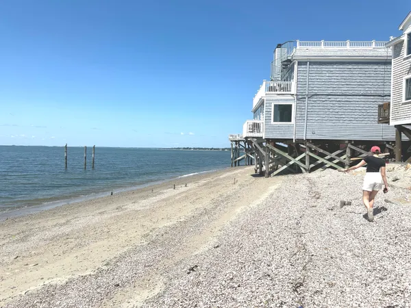 a view of a ocean with wooden fence