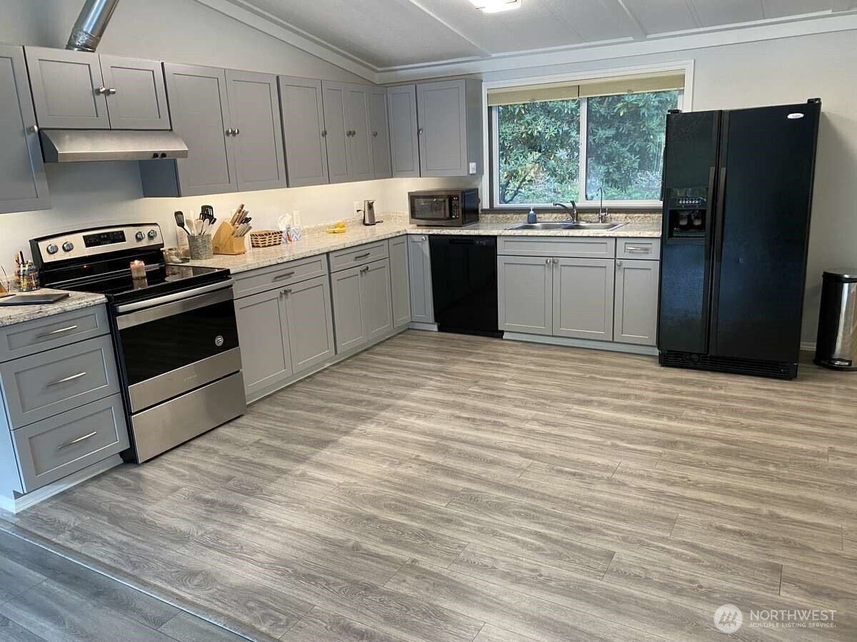 111 North Jorstad Creek Road Lilliwaup, WA 98555 - Photo 2 of 23 a kitchen with stainless steel appliances granite countertop a refrigerator sink and stove