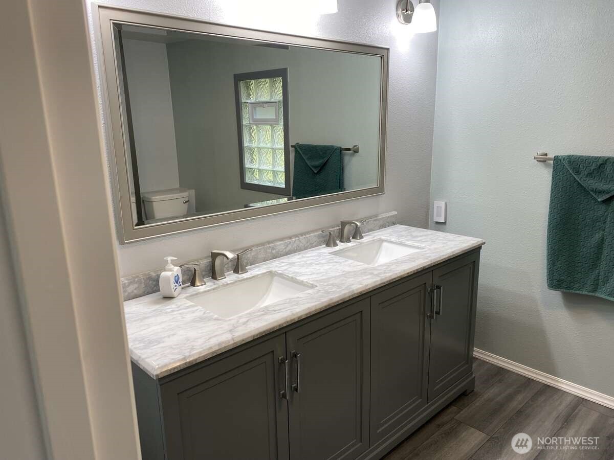 111 North Jorstad Creek Road Lilliwaup, WA 98555 - Photo 3 of 23 a bathroom with a granite countertop sink and a mirror