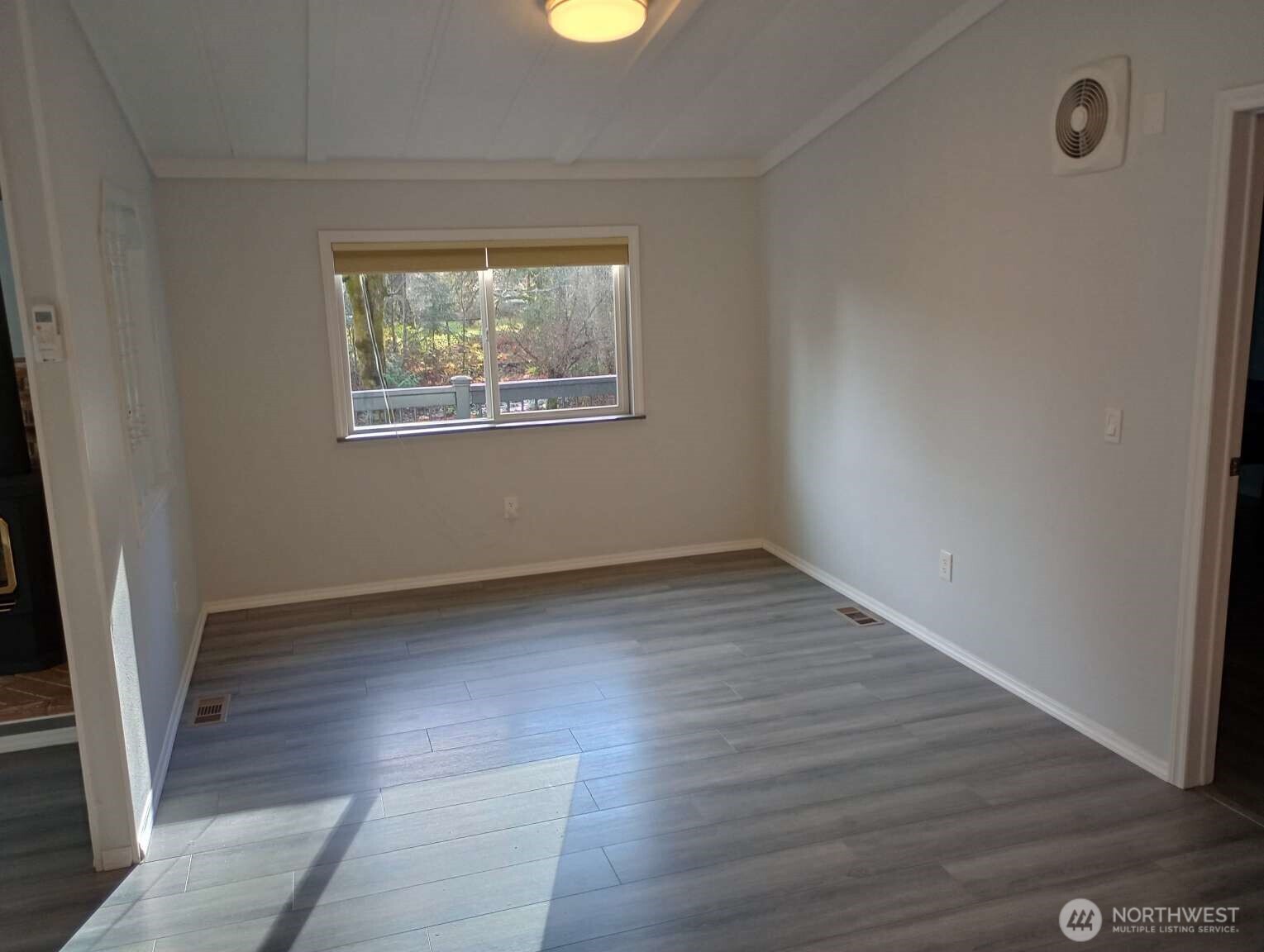 111 North Jorstad Creek Road Lilliwaup, WA 98555 - Photo 8 of 23 an empty room with wooden floor and windows