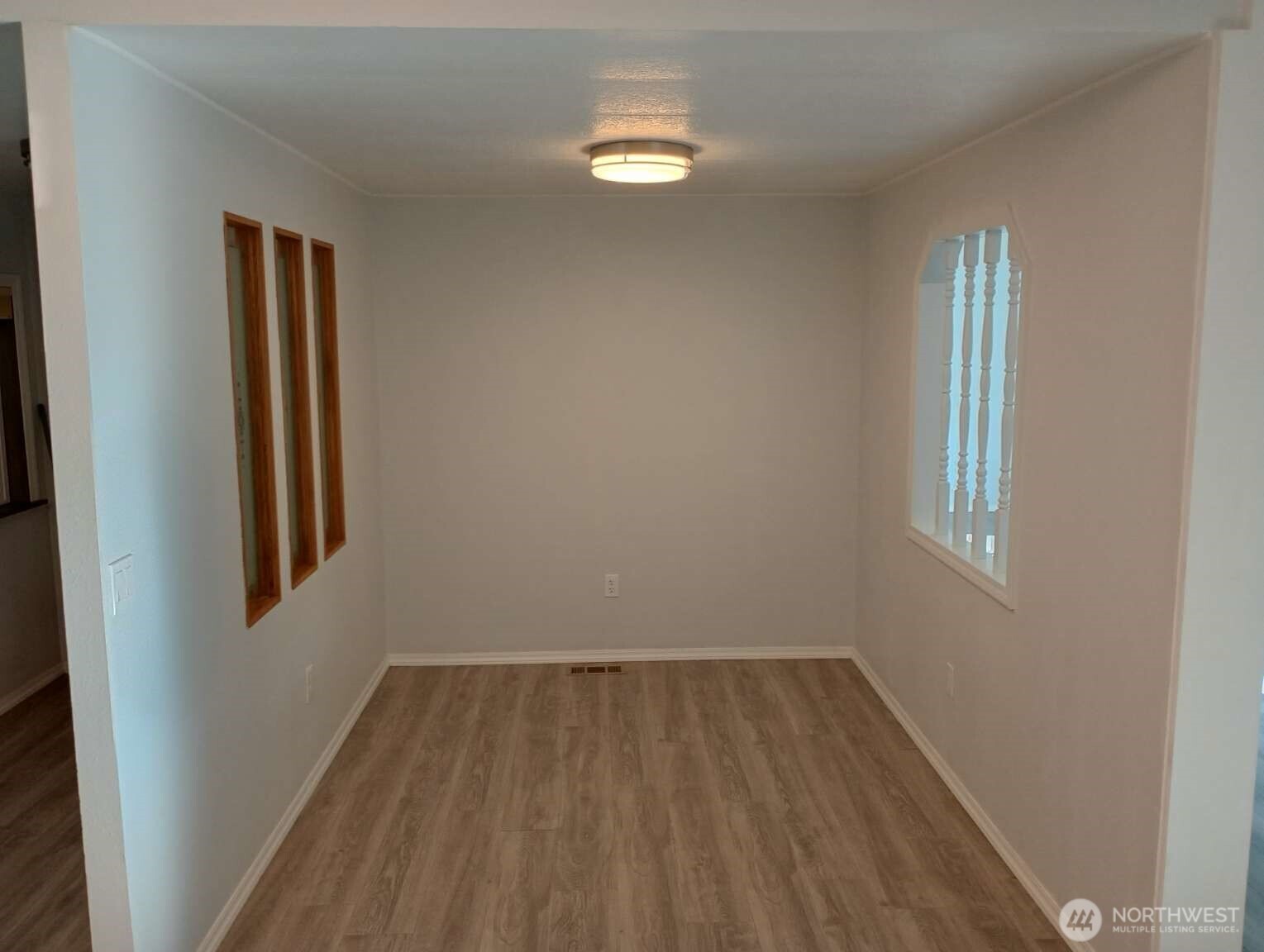 111 North Jorstad Creek Road Lilliwaup, WA 98555 - Photo 9 of 23 an empty room with wooden floor and windows