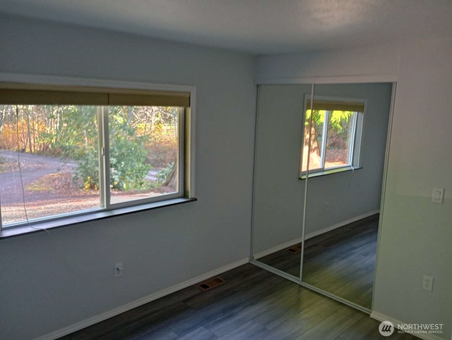 111 North Jorstad Creek Road Lilliwaup, WA 98555 - Photo 10 of 23 a view of an empty room with wooden floor and a window