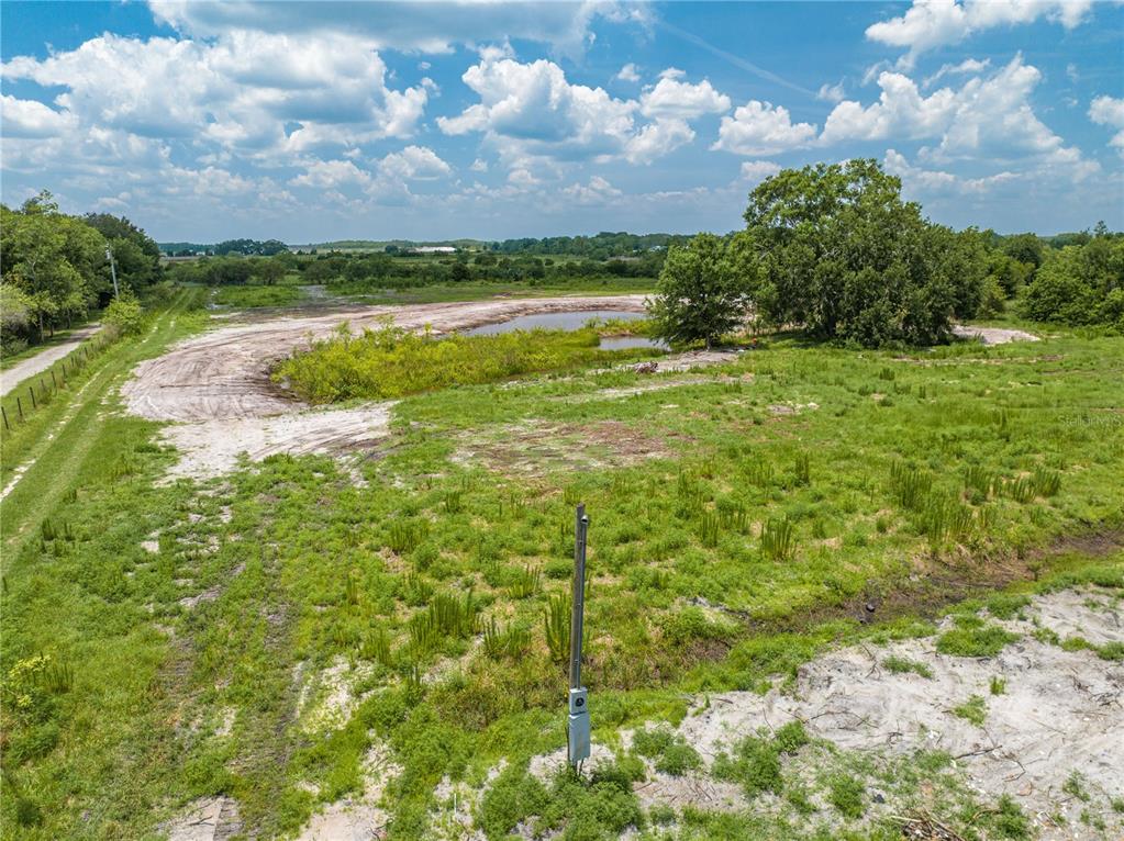 5420 Holopaw Road St. Cloud, FL 34773 - Photo 15 of 16 a view of a lake with houses in the back