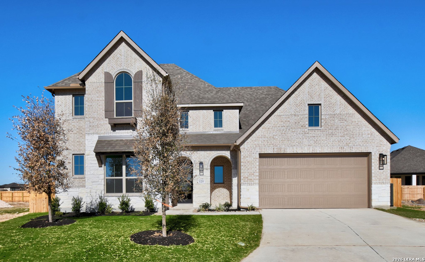 a front view of a house with a yard and garage