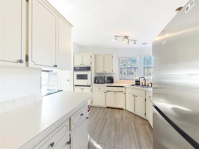 a kitchen with granite countertop cabinets stainless steel appliances and a sink