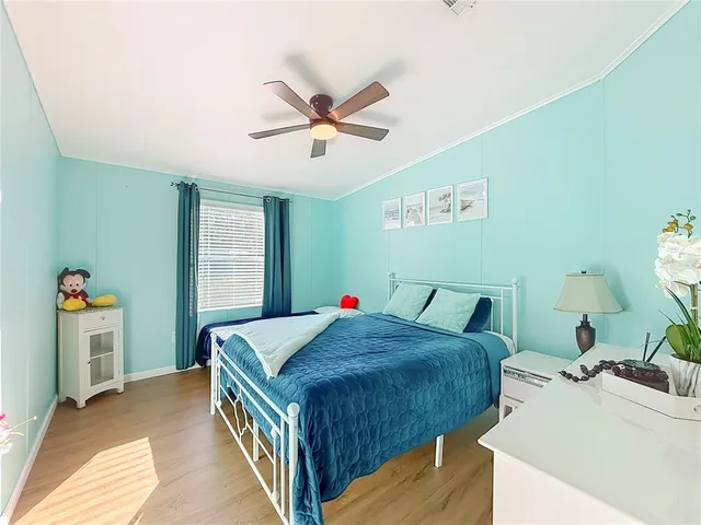 a bedroom with a bed and wooden floor
