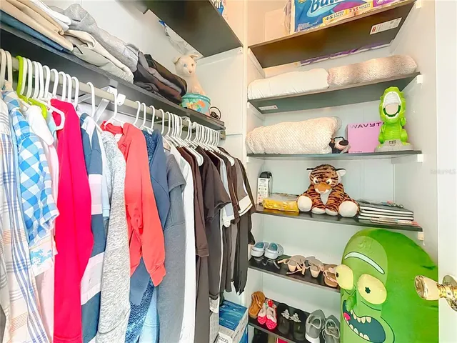 a bathroom with a granite countertop toilet sink and mirror