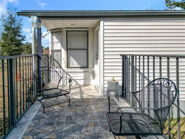 a view of kitchen with kitchen island wooden floor and stainless steel appliances