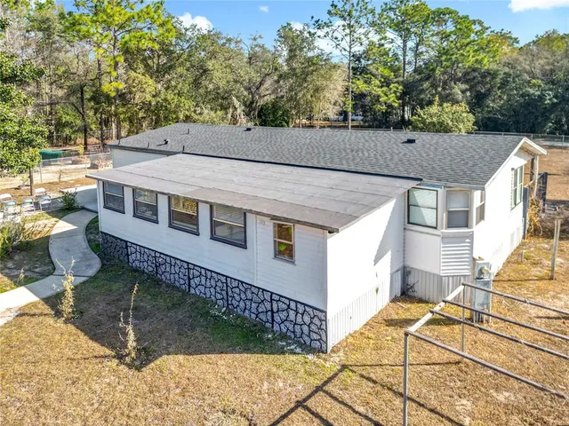 a view of a backyard with sitting area