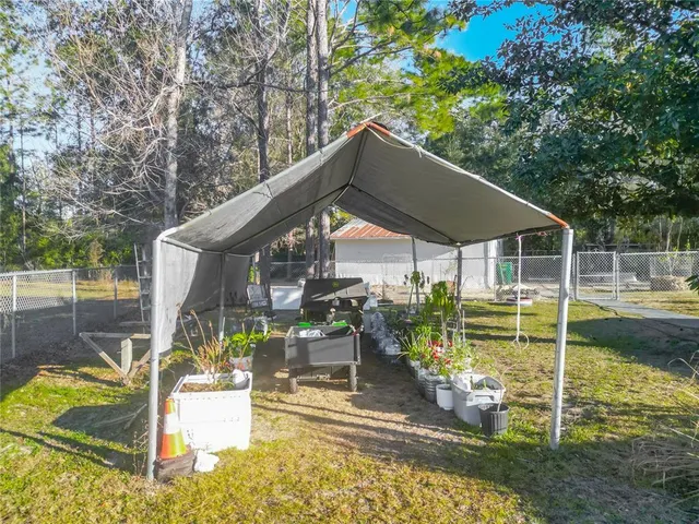 a view of a patio with table and chairs near an umbrella