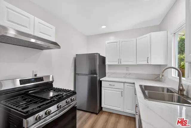 a kitchen with a stove and a refrigerator