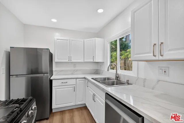 a kitchen with a refrigerator and a sink