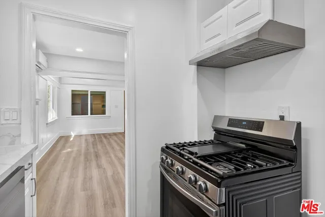 a kitchen with wooden cabinets and a stove top oven
