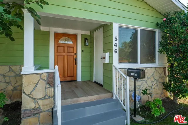 an entrance to house with yard