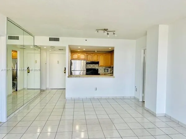 a kitchen with granite countertop a refrigerator and a stove top oven