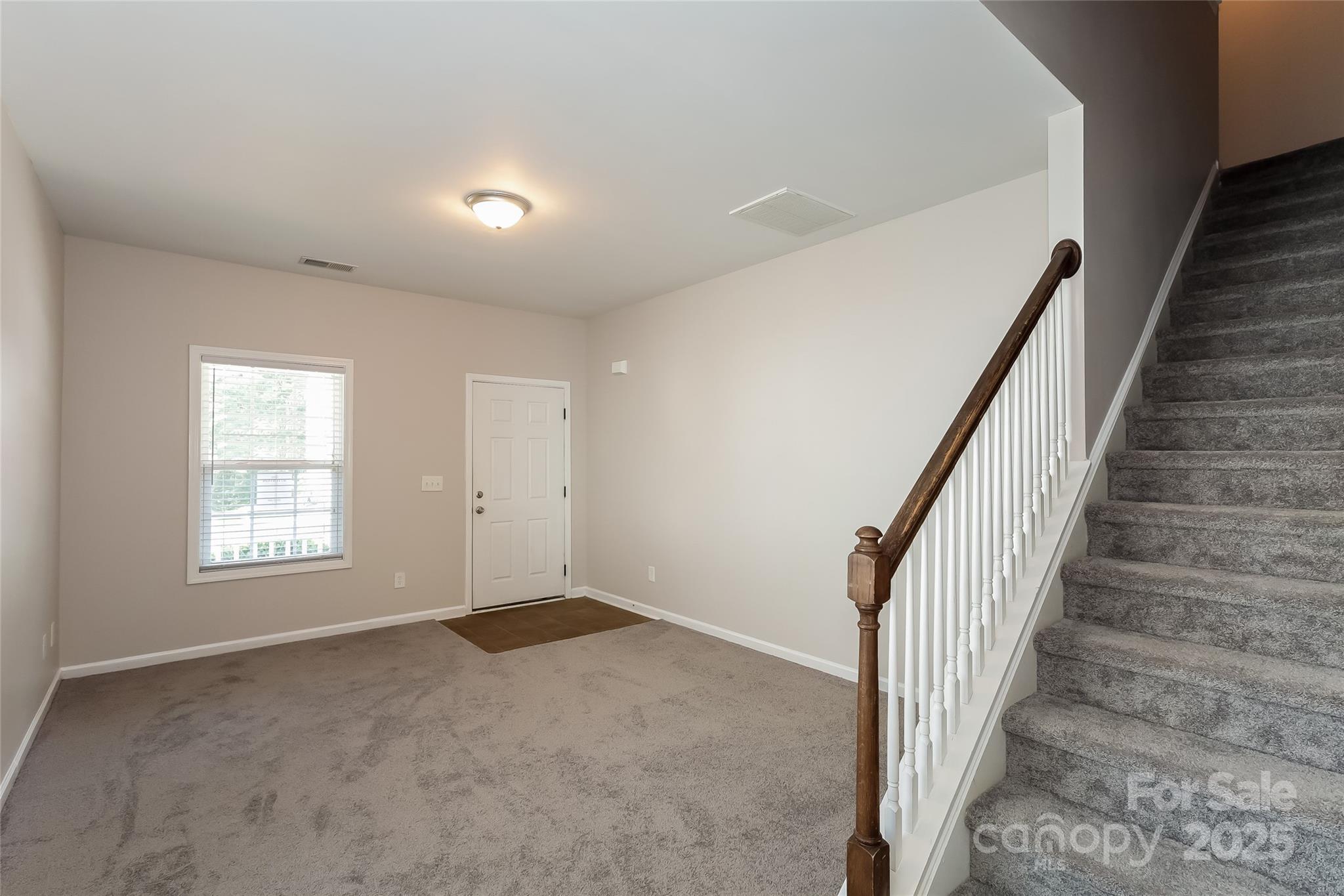 437 Danielle Way Fort Mill, SC 29715 - Photo 5 of 15 a view of an empty room with wooden floor and stairs