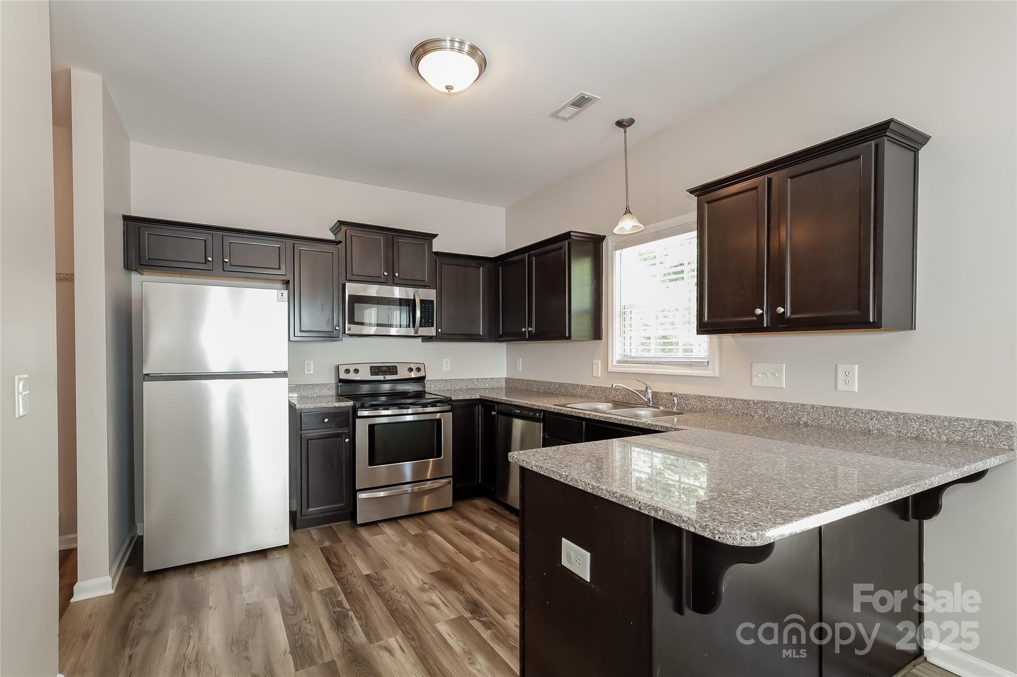 437 Danielle Way Fort Mill, SC 29715 - Photo 7 of 15 a kitchen with stainless steel appliances granite countertop a sink stove and refrigerator