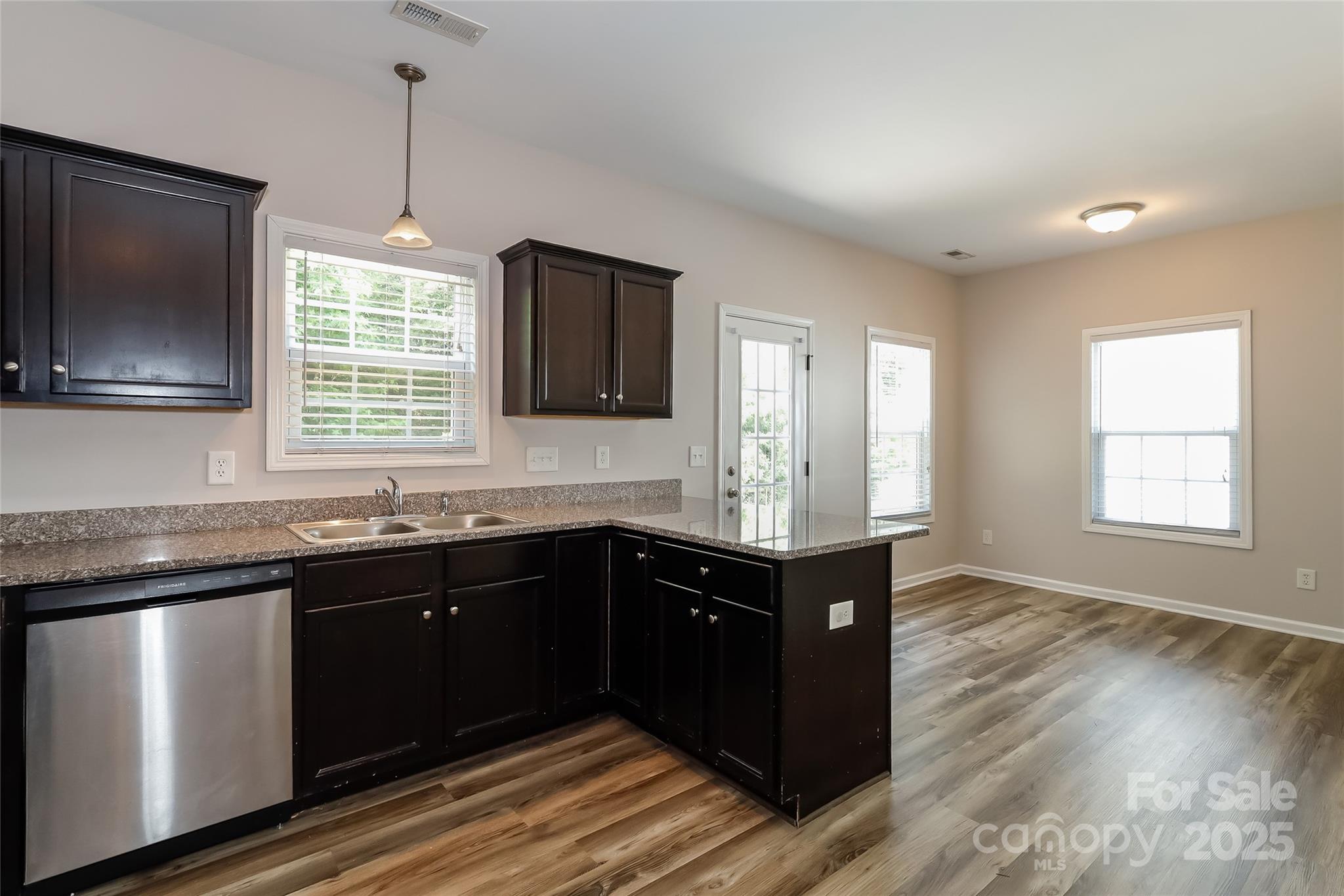 437 Danielle Way Fort Mill, SC 29715 - Photo 9 of 15 a kitchen with granite countertop stainless steel appliances a sink stove and wooden floor