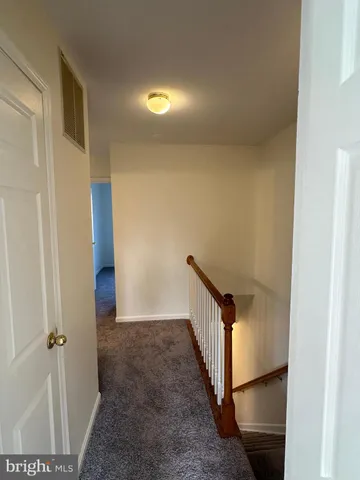a view of hallway with wooden floor