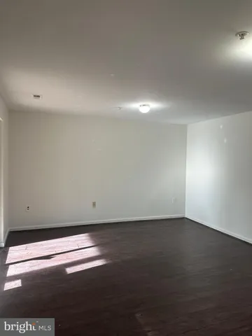 a bathroom with a granite countertop sink and a toilet