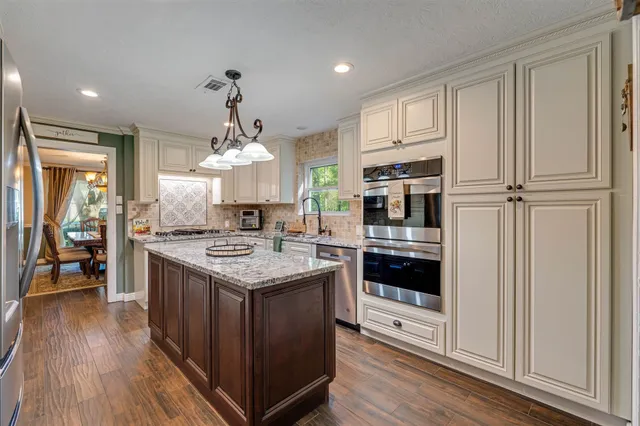 a kitchen with a stove oven and sink