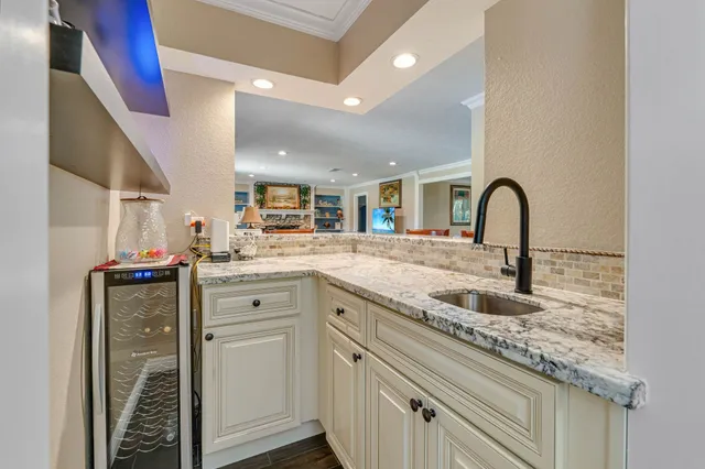 a kitchen with sink and white cabinets