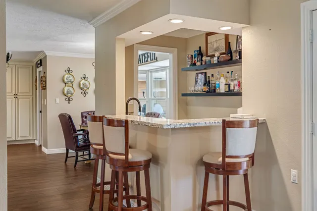 a dining room with furniture and wooden floor